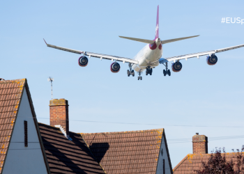 Airplane landing with blue sky background