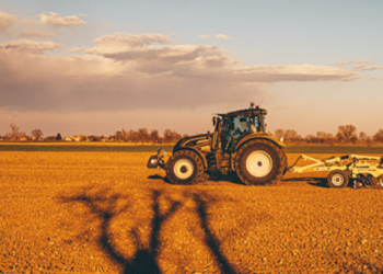 Tractor performing agriculture tasks